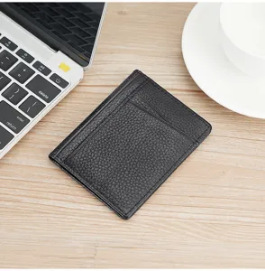Slim black pebbled leather driver's license holder on a wooden office desk background
