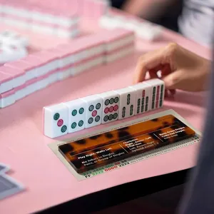 Tortoise shell acrylic mahjong line reader used on a game card in a social setting