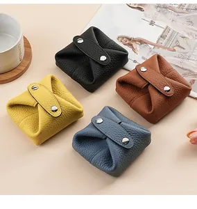 Multiple colors of genuine leather mini coin purses with pebbled texture and snaps
