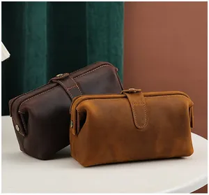 Macro view of vintage crazy horse leather cosmetic bags on a white table