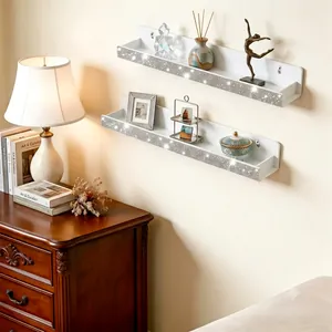 Macro view of white acrylic wall shelf with sparkling crystal rhinestone decorative trim