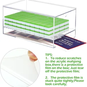 Detail view of transparent acrylic mahjong box showing protective film removal instructions.
