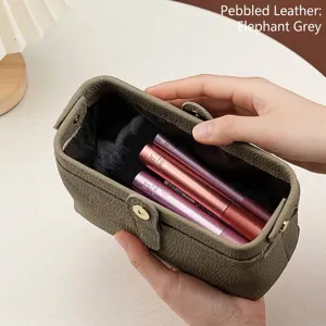 Large capacity genuine litchi grain leather makeup bag in elephant grey shown held by hand