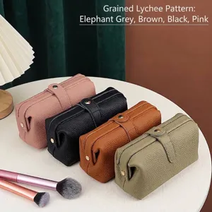 Four-color genuine lychee grain leather large capacity cosmetic bags on table