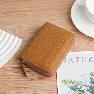Brown genuine pebbled leather RFID accordion card holder for women in lifestyle setting