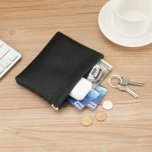 Compact black lychee pattern leather coin purse with spring snap closure