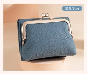 Detail view of stylish blue pebbled leather tri-fold kiss-lock coin purse for women
