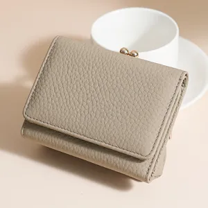 Elegant taupe pebbled leather three-fold wallet for women with kiss-lock closure