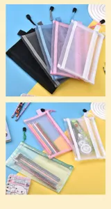 Detailed view of colorful transparent mesh pencil cases with stationery items inside