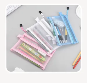 Detail view of three multi-layer mesh pencil cases in pink, white, and blue colors