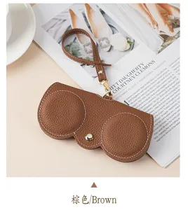 Detailed view of the brown leather sunglasses case featuring a pebbled texture finish