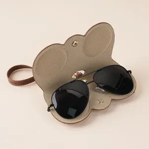 Handcrafted brown leather sunglasses storage case with portable strap and soft inner lining