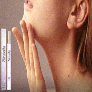Detailed macro view of a portable rollerball perfume bottle shown with model application.
