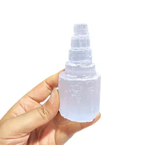 Natural white Morocco selenite crystal tower held by hand for meditation home decor