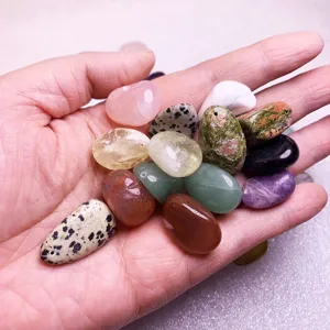 Close-up macro view of assorted polished natural crystal stones and drilled beads for DIY jewelry