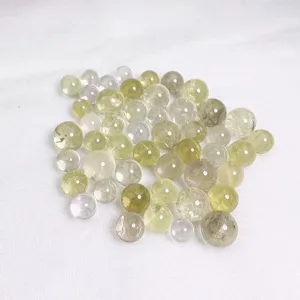 Close-up macro view of translucent natural crystal beads for DIY jewelry with varied pale hues