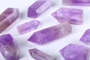 Close-up macro view of natural hexagonal amethyst crystal pillars with single points