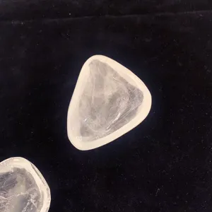 Vue macro détaillée d'un bol en cristal clair irrégulier sur fond de velours noir.