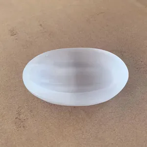 Detailed top view of a translucent white natural selenite stone bowl for crystal healing