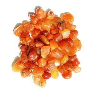 Close-up of polished natural carnelian agate stones with vibrant red and orange tones