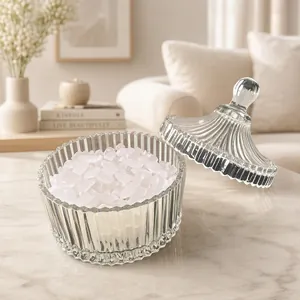 Natural white crystal stones in an elegant ribbed glass bowl for jewelry purification