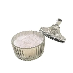 Natural white crystal purifying stones in a transparent ribbed glass jar container