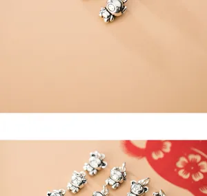 Macro view of vintage S925 Thai silver Chinese zodiac charms for DIY bracelet making