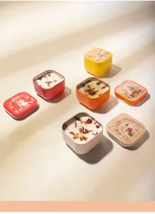 Detail view of colorful tin scented candles with dried flower petals and bunny lids