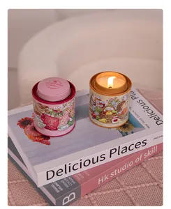 Detailed view of two decorative tin jar candles with cute animal illustrations