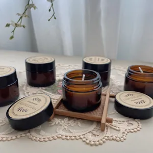 Detail of 35g soy wax scented candles in amber glass jars with minimalist brown labels