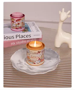 Close-up of a lit scented candle in a decorative rabbit-themed tin on a marble plate
