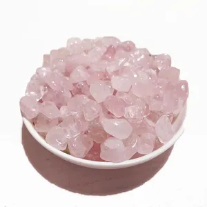 Natural pink rose quartz crystal gravel stones for home decor and degaussing in a white bowl