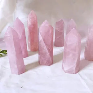 Close-up of natural pink rose quartz crystal hexagonal wands for healing decor