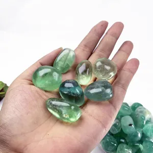 Detailed view of natural green fluorite tumbled stones, polished mineral specimens for DIY decor.
