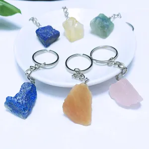 Detailed view of assorted natural raw crystal stone keychains in diverse colors