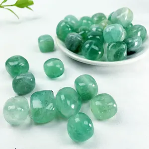 Close-up of polished green fluorite tumbled stones detail, raw mineral crystal specime