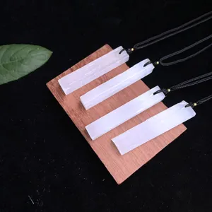 Detailed view of natural white selenite stone bar pendants on a wooden display block