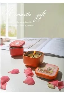 Close-up of a lit scented candle in an orange tin with rabbit illustration and petals.