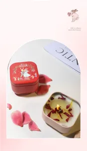 Detailed macro view of smokeless scented candles in decorative red tins with flower petals