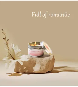Close-up of a rose essential oil scented candle with dried petals on a stone