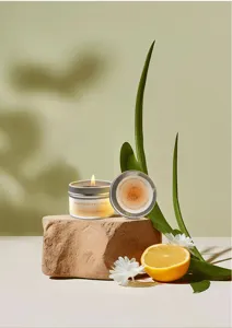 Detailed view of burning grapefruit and sweet orange aromatherapy soy wax candle