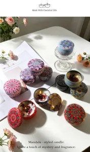 Elegant mandala styled scented soy wax candles with dried flowers in decorative metal tins