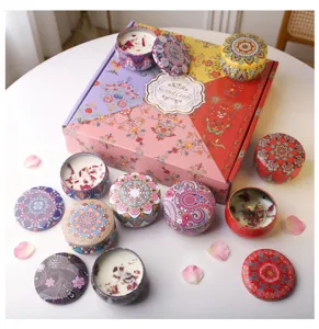 Detailed view of colorful mandala tin candles featuring dried flower petals in a gift set box