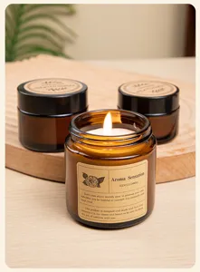 Detailed close-up of a burning scented soy wax candle in a vintage amber glass jar.