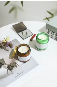 Lifestyle detail of Aroma Sensation soy wax candles in amber and green glass jars