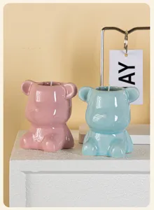 Aesthetic close-up of pink and blue ceramic bear-shaped soy wax scented candles for home decor