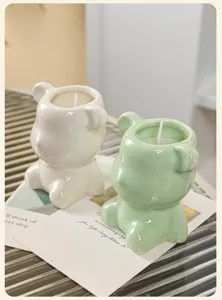 Two cute bear-shaped ceramic scented candles in white and mint green for home decor
