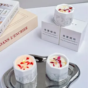 Handmade soy scented candle in marble texture plaster cup with dried flower petals
