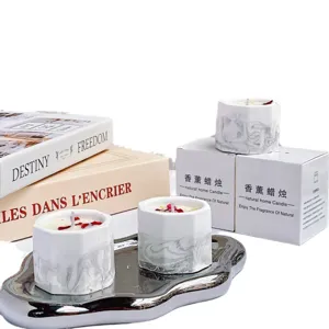 Elegant marble patterned soy wax candles in hexagonal gypsum cups on a silver tray