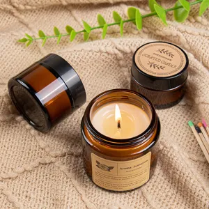 Handmade scented soy wax candle in amber glass jar with creative craft paper label